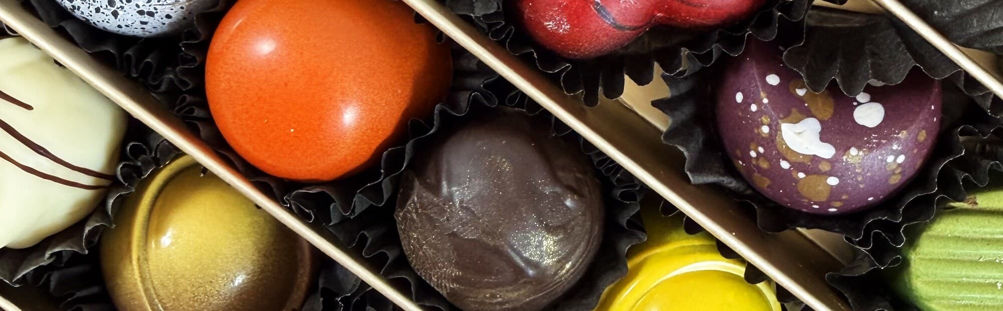 Hand-finished chocolates in a gold-lined box